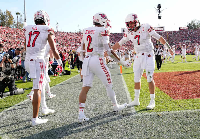 Cam Rising (right right) embraces teammates at the Rose Bowl.